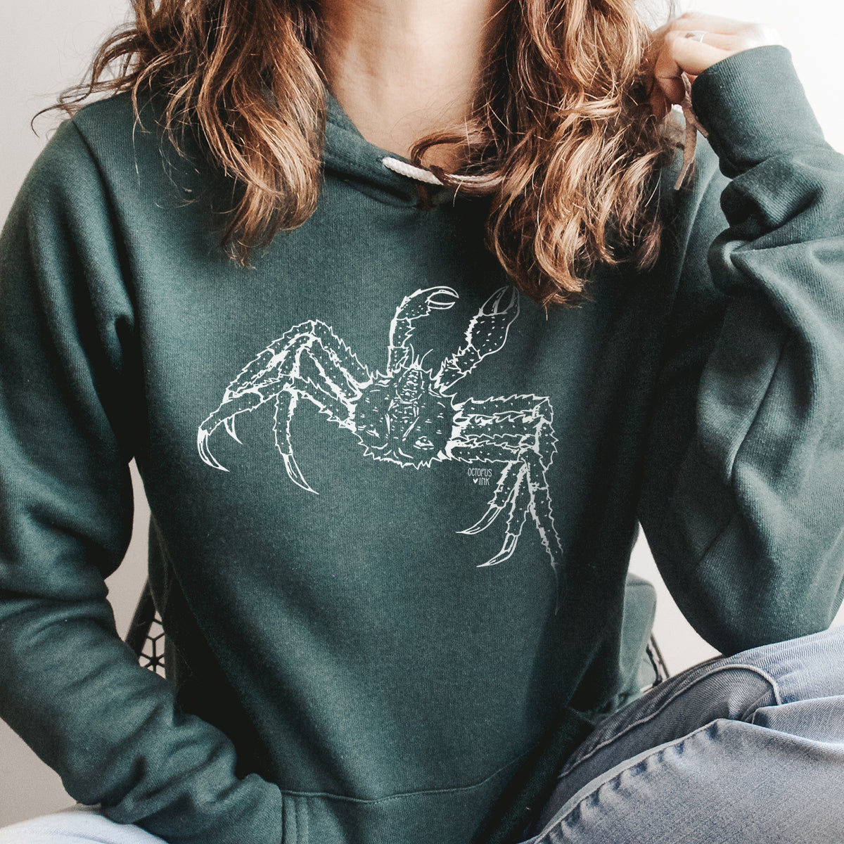 hand drawn alaskan king crab design on a green pullover hoodie