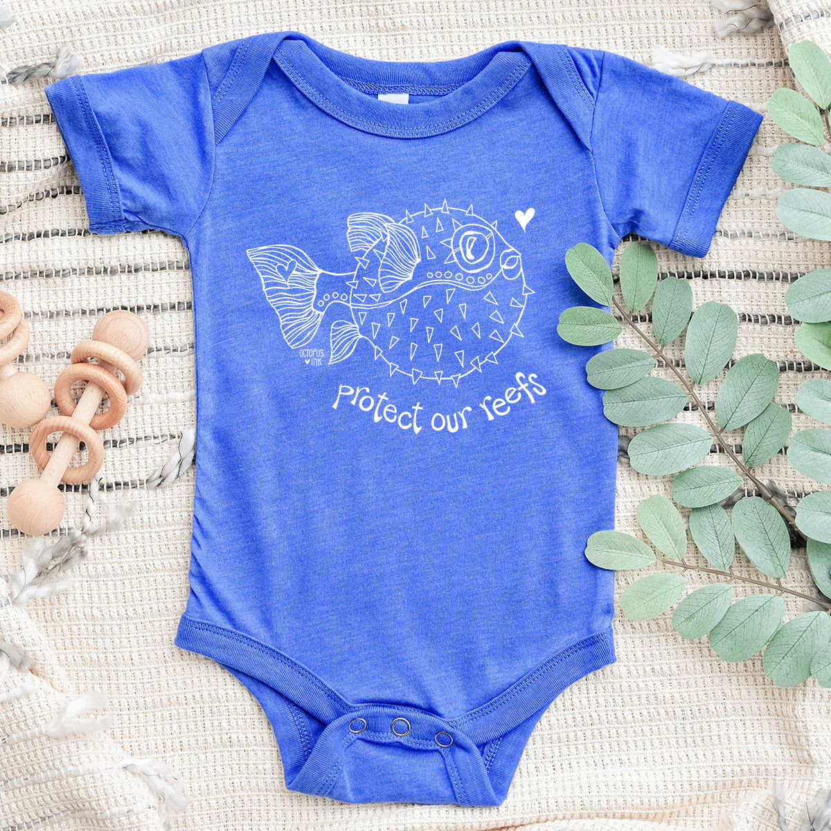 hand drawn puffer fish design on blue baby bodysuit
