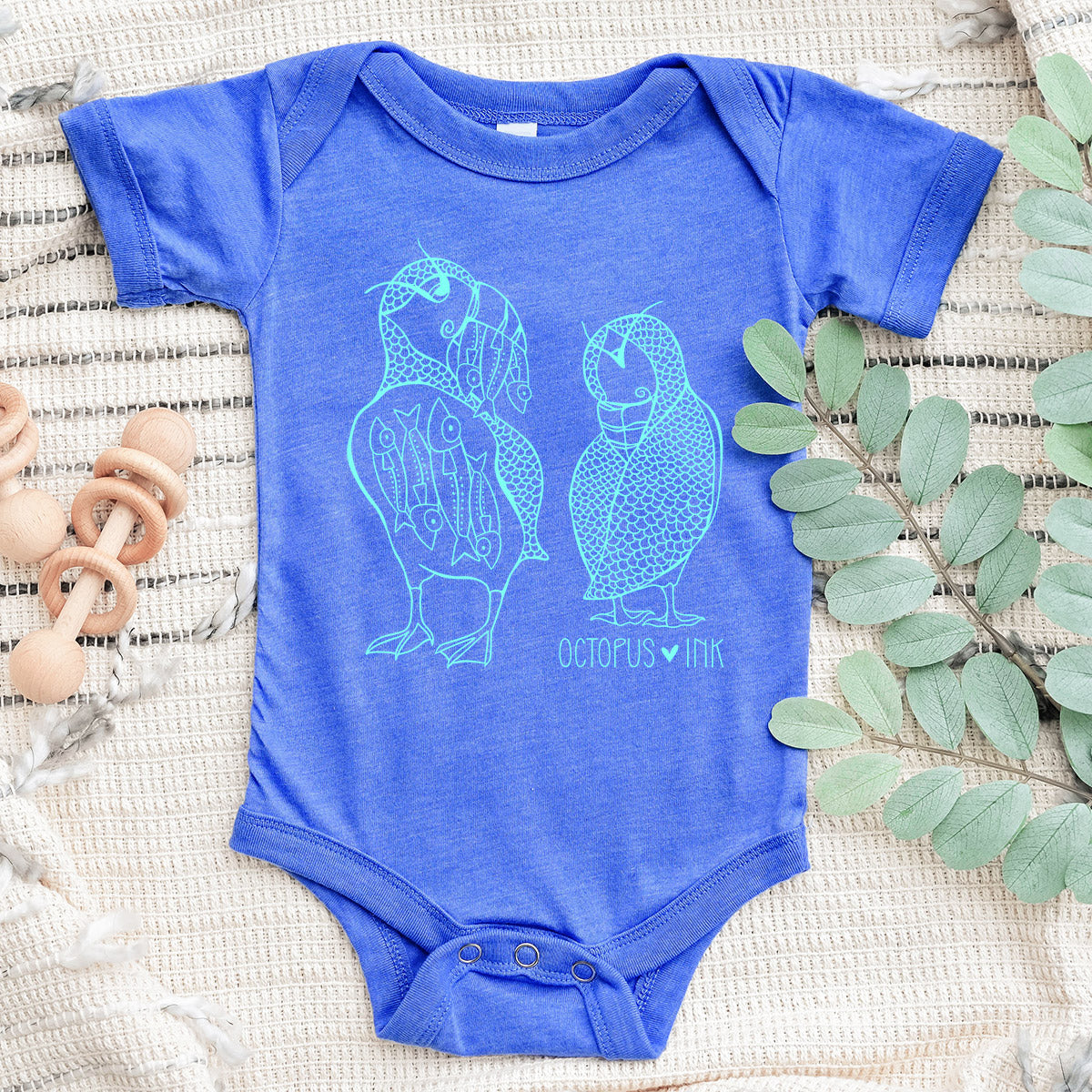 hand drawn puffin design on blue baby bodysuit