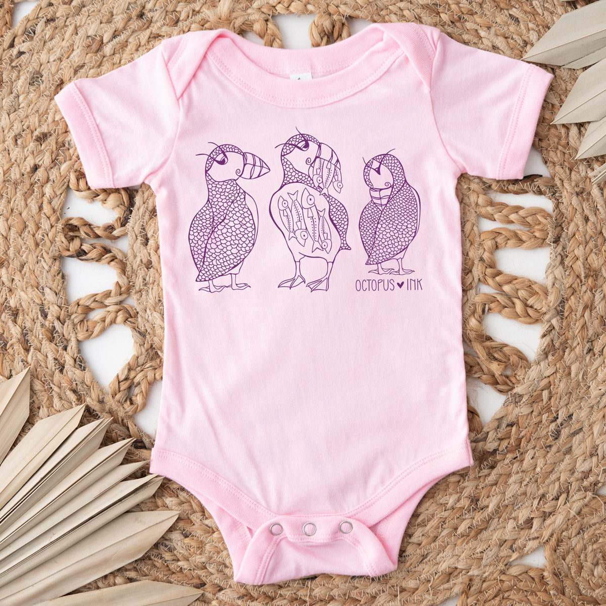 hand drawn puffin design on pink baby bodysuit