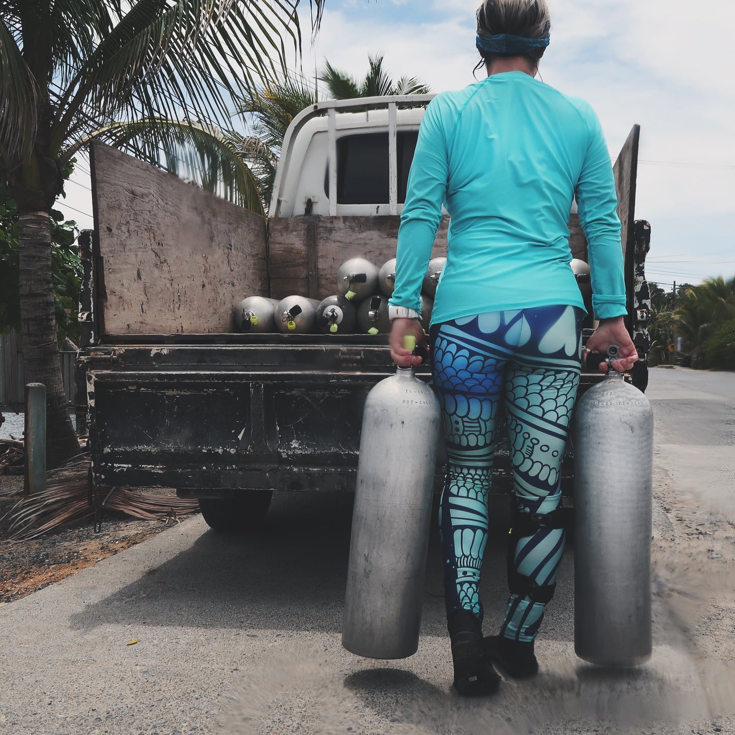 mermaid inspired ladies leggings with scales, arrows, and hearts in blues and greens