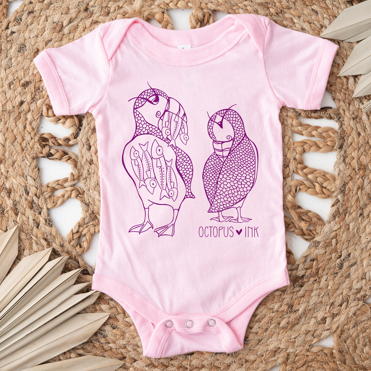 two puffin design on a pink baby bodysuit